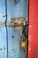 Wooden door with bolt and padlock