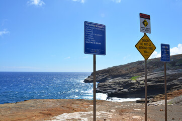Blue ocean & blue sky beyond the three sign poles at Lanai Lookout, Honolulu, Oahu Island, Hawaii