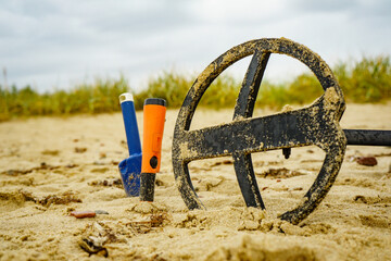 Metal detector with accessories on beach
