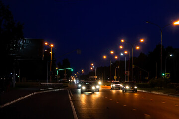 photo city at night, road, cars in the artistic treatment