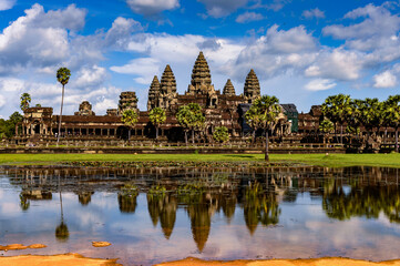 Naklejka premium It's Angkor Wat (Temple City) and its reflection in the lake, a Buddhist, temple complex in Cambodia and the largest religious monument in the world. View from the garden