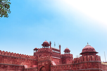 A huge fortress of Mughal empire in India with high walls on a sunny summer afternoon. Red fort of...