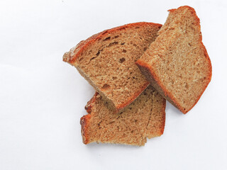 black bread sliced on a white background.