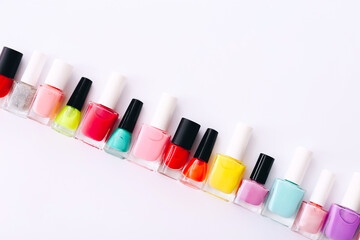 Group of nail polishes of different colors on white background