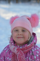 A girl walks through a winter snow-covered forest 
