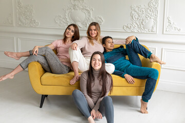 Girl friends at home watching television. Group of women with different body and ethnicity