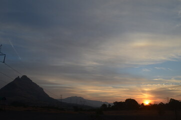 Amazing Sunrise with mountains forests and clouds with Blue orange saffron golden sky