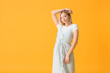 Portrait of beautiful young woman on color background