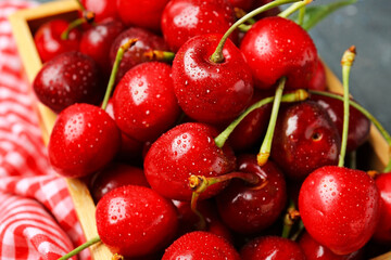 Box with sweet cherry on table, closeup