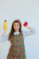 Housekeeper in uniform with clean spray, sponge. housekeeper or happy wife cleaning with soap bottle and duster