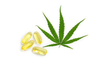 Hemp oil capsules and cannabis leaves on a white background, CBD hemp oil, medical marijuana concept.
