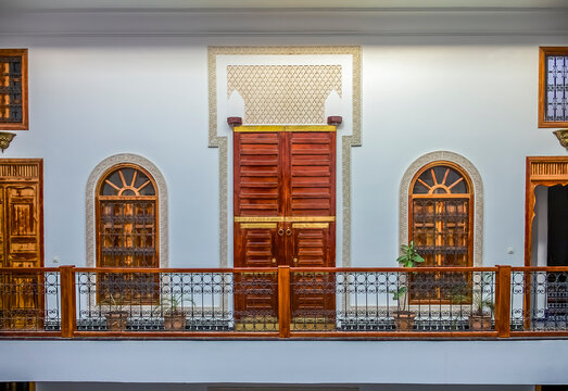 Mosaic tile on the walls, Moorish arch and cedar carved doors in an inner courtyard of a typical Moroccan riad in Fes, Morocco