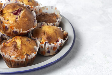 Homemade muffins with red berries and cherries