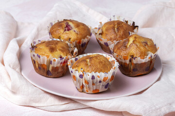 Homemade muffins with red berries and cherries