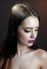 Fashion studio shot of young beautiful woman with bright makeup. Closeup