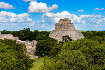 Fototapeta na wymiar Pyramid of the Magician in the jungle, a Mesoamerican step pyramid, Uxmal, an ancient Maya city of the classical period. UNESCO World Heritage site