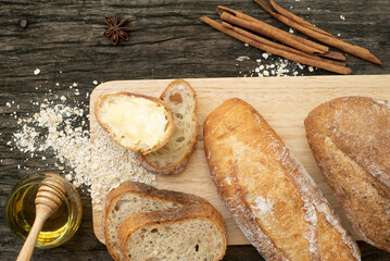A closeup top view of freshly baked traditional Italian Ciabatta breads prepared and cut in to slices on a wooden table read to be served