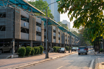 Fototapeta na wymiar Hanoi street with automated level stacked car parking lot in Hanoi