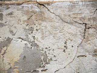 old cracked concrete wall, cracked plaster.