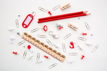 Assortment school or office red stationery, pencils, pins, clips, ruler, isolated on white background