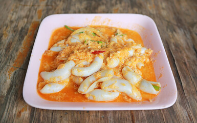 Stir fried fresh squid with yoke eggs, onion and chilli