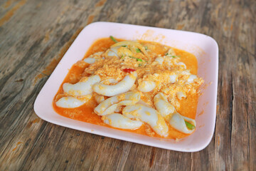 Stir fried fresh squid with yoke eggs, onion and chilli.