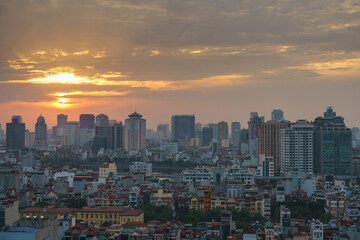 Fototapeta na wymiar Hanoi cityscape at sunset with arising high buildings in Dong Da district
