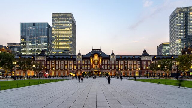 4K UHD time-lapse of Tokyo Station at day to night with Japanese people walking in front of station. Tokyo tourist attraction, Japan tourism and asian city life or transportation concept