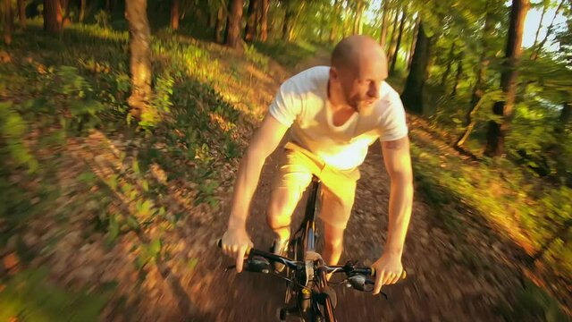 Man enjoying crazy, offroad bicycling. Summer, forest trip