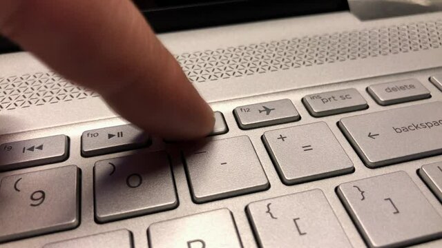 Person finger tapping on F11 button on keyboard. Finger pressing F11 key repeatedly. System recovery mode.