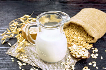 Milk oatmeal in jug on burlap