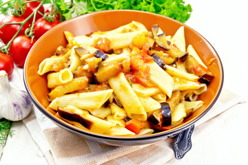 Pasta penne with eggplant and tomatoes on board