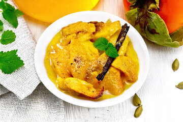 Persimmons baked with honey in dish on table