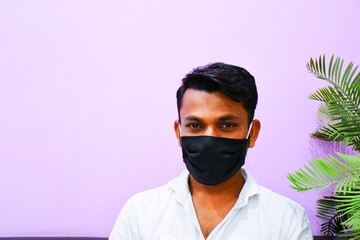 Masked man - protection against influenza virus. Indian man wearing mask for protect. man wear with protective face mask at home. Stop the virus and epidemic diseases.