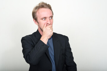 Portrait of stressed businessman with blond hair looking shocked