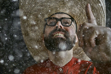 man in sombrero hat with brim, mexican style, latin america, snow cold winter christmas background