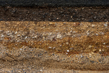 The layer of asphalt road with soil and rock.