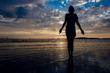 Happy Carefree Woman Enjoying Beautiful Sunset on the Beach