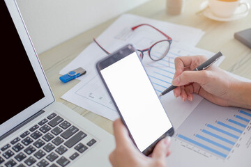 close up of a female hands working on desk work with stationary items in home.
