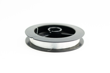 reel with fishing line on a white background
