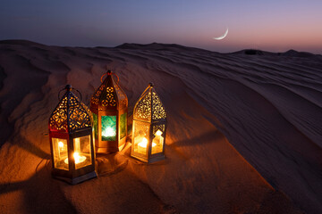 Lanterns in desert   lit against a crescent moon night sky during Ramadan Eid time