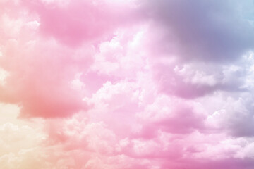 Colorful puffy fluffy cloud & cotton candy cloudscape on sunrise or sunset sky in tropical summer or spring sunlight & sun ray with gradient colors of blue, pink, purple, white & gray, surreal concept