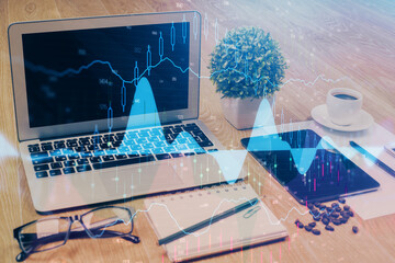 Financial graph colorful drawing and table with computer on background. Double exposure. Concept of international markets.