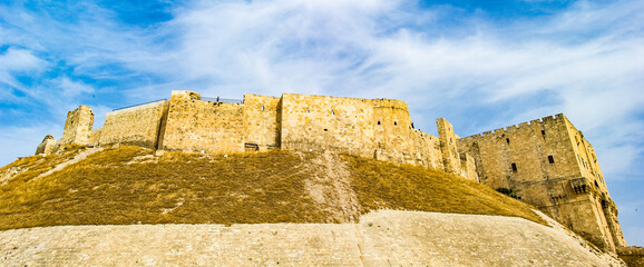 It's Aleppo castle on the hill, in Syria