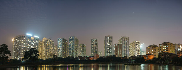 Fototapeta na wymiar Panorama of Hanoi city cityscape at sunset with reflection of apartment buildings skyline in 2020