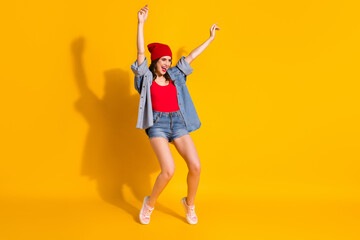 Full length photo positive youngster hipster girl dance spring weekend discotheque night club raise hands wear red headwear good look clothes sneakers isolated bright color background