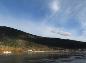 the view from a ferry going from West Dawson to Dawson City in the month of September, Canada