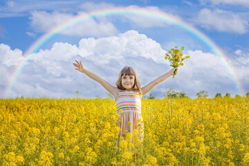 A child in a yellow rainbow field. Selective focus.