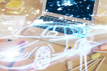 Desktop computer background in office with automobile hologram drawing. Multi exposure. Tech concept.