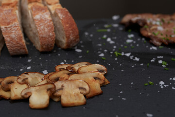 mushrooms in the foreground, bread and meat background